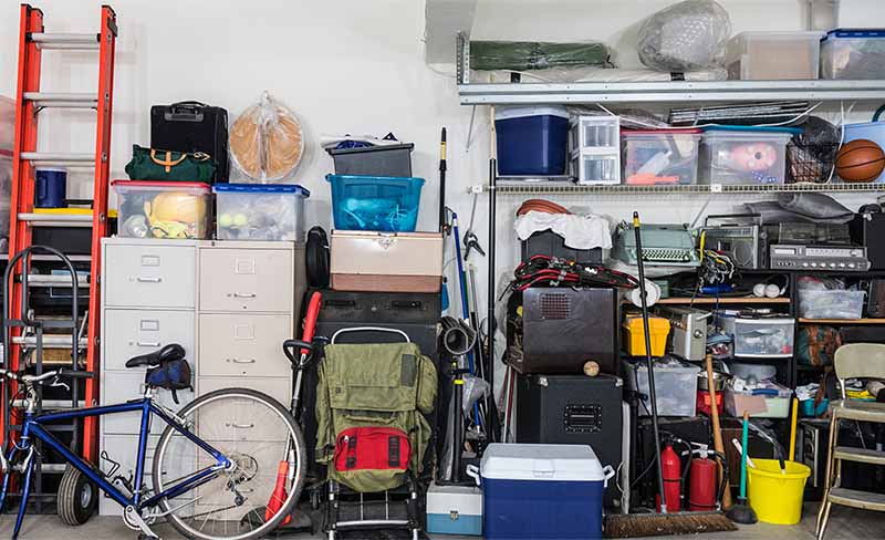 A fully cluttered garage with no space left to store additional tires.